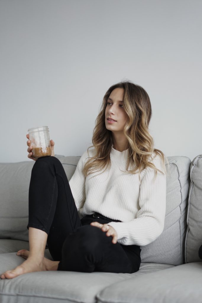 Sitting woman sitting on a sofa with an iced coffee in hand. 
"How to Plan The Perfect Branding Photoshoot" 